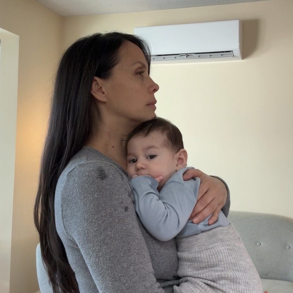 Glenda holding a baby upright in a calming hold